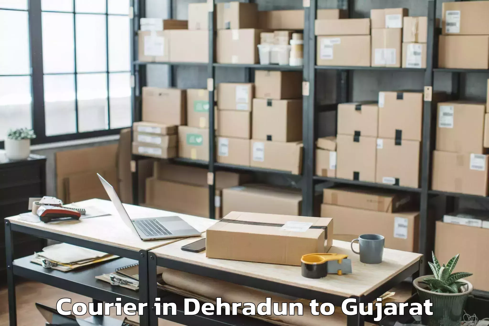 Book Dehradun to Vaghodia Ina Courier